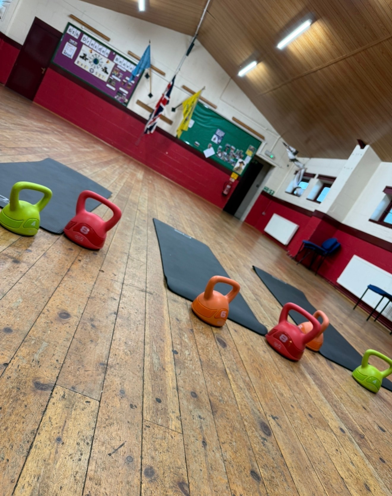 Kettlebells and yoga mats set up for a Women's Health Circles exercise session